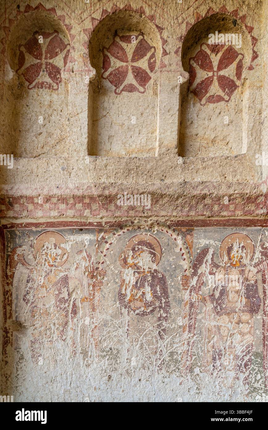 A faded fresco of saints covers the wall in the Dark Church, Goreme ...