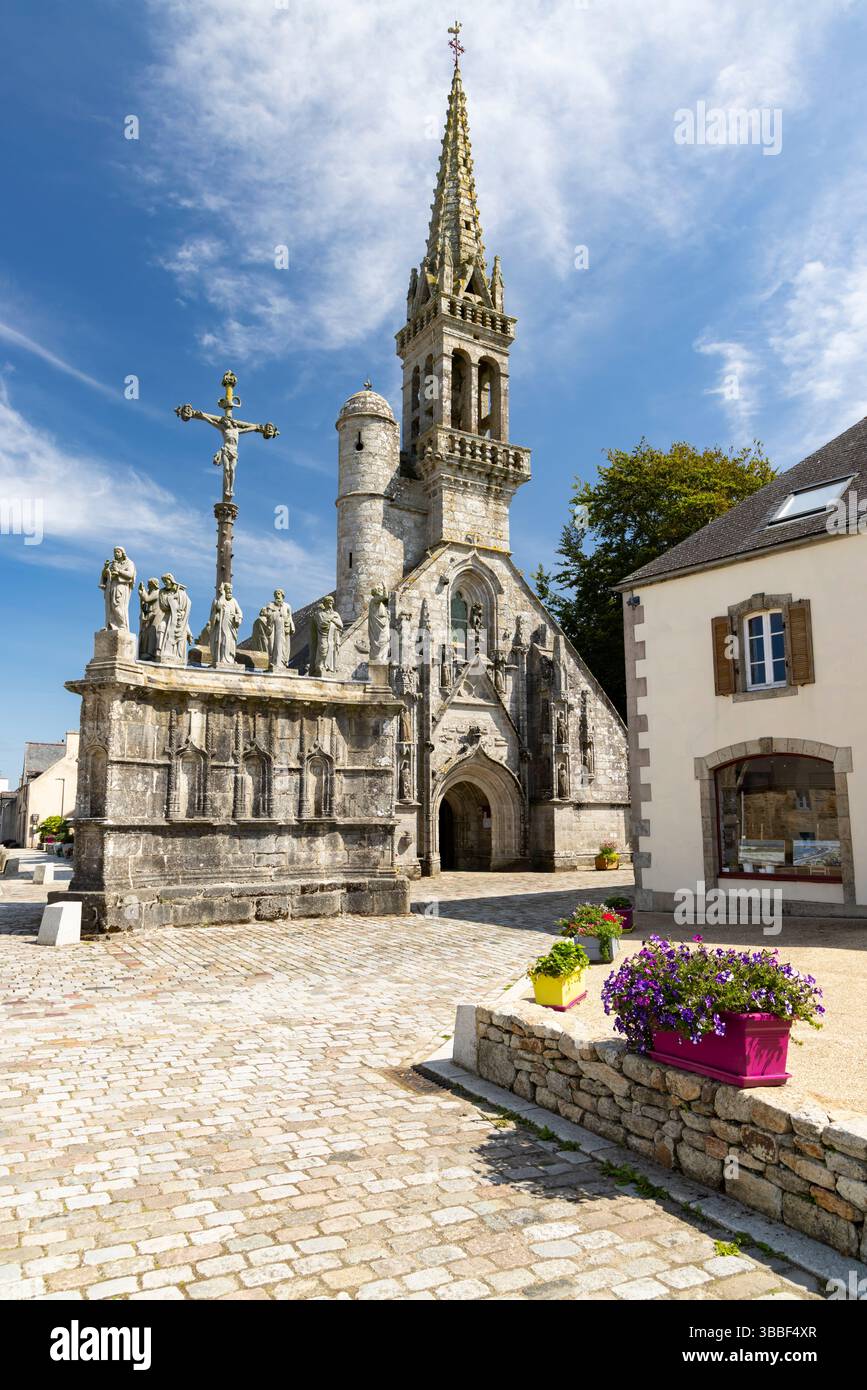 Cobblestone square and calvary in front of Notre Dame de Confort church in Confort Meilars, Finistere, Brittany, France Stock Photo