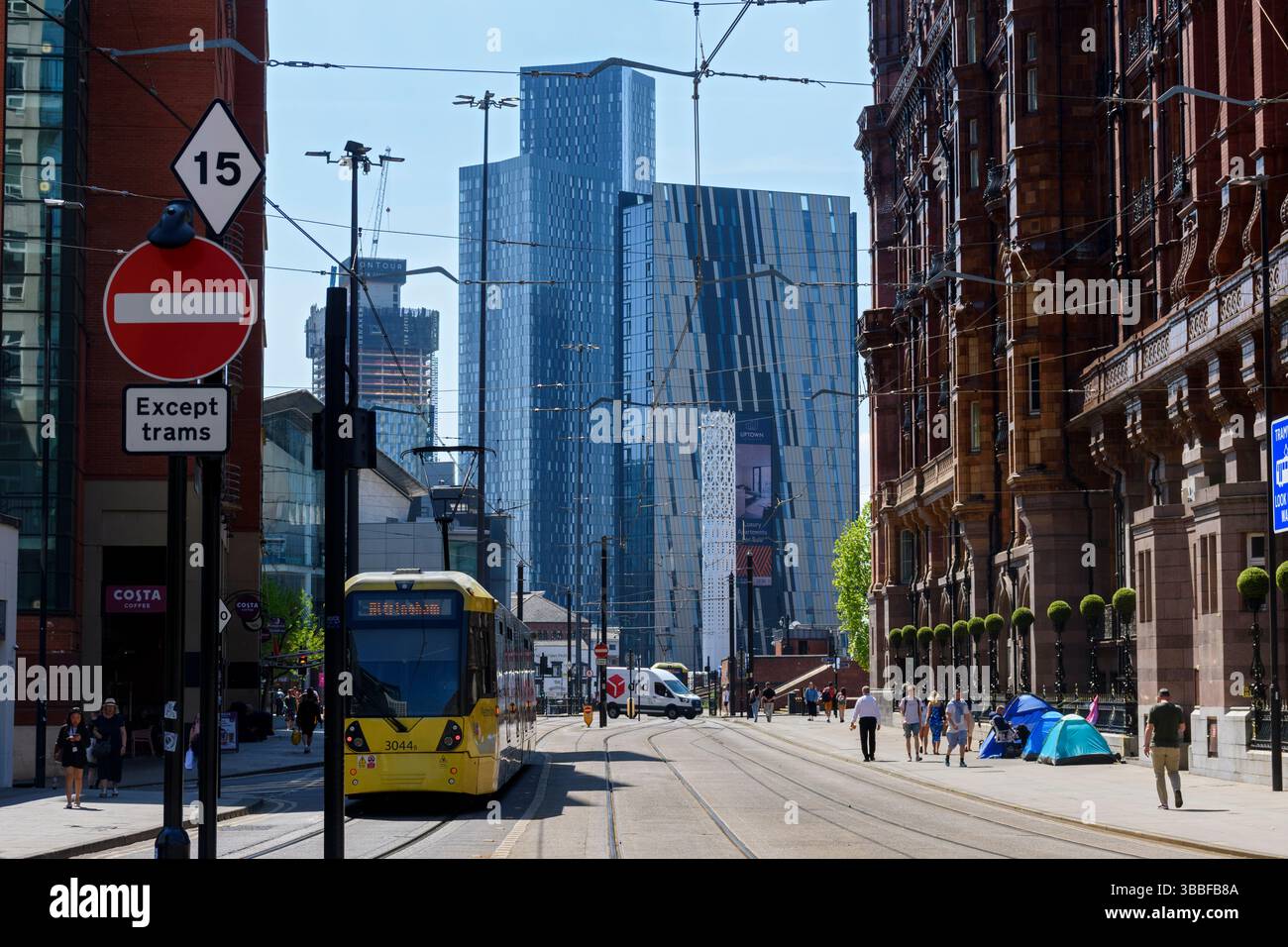 The Axis and Deansgate Square apartment blocks with a Metrolink tram passing the Midland Hotel, Lower Mosley St., Manchester, UK Stock Photo