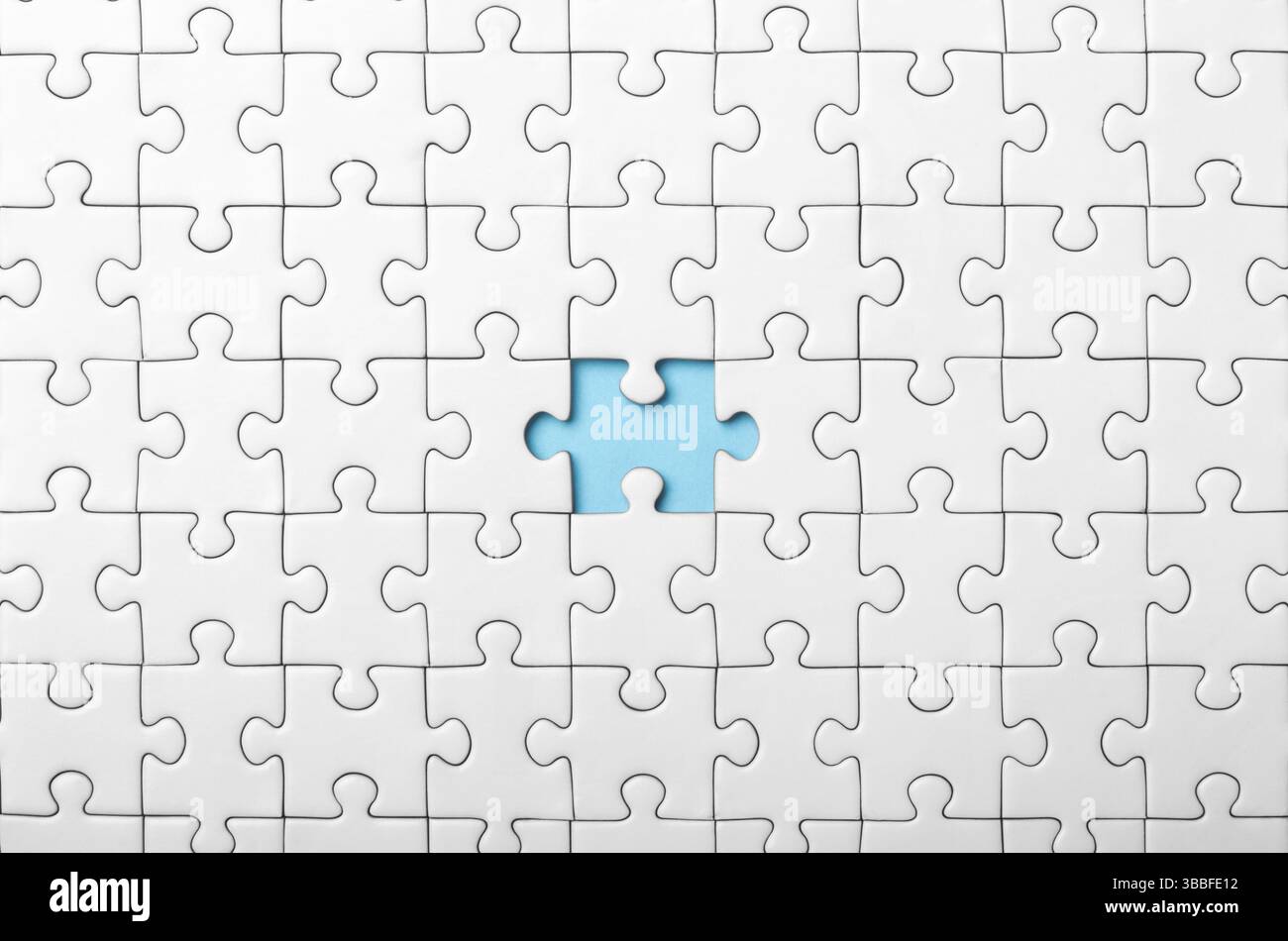 White Puzzle with Single Missing Piece Revealing blue Background Stock Photo