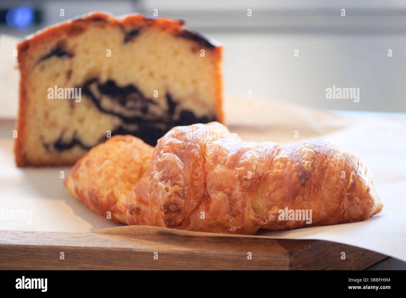 Delectable pastries and loaf on a wooden surface Stock Photo