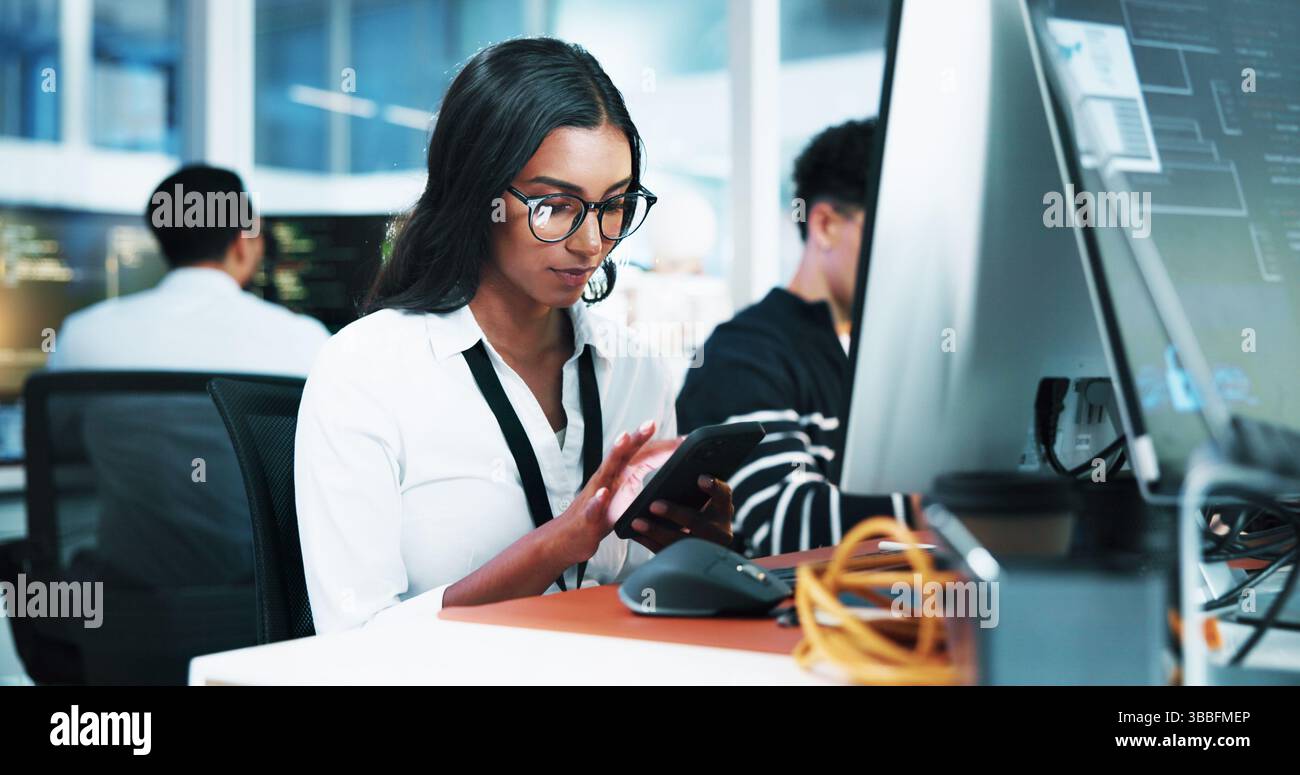 Computer, businesswoman and developer with smartphone in office, coding software and download app. Coworking, female person and programmer with mobile Stock Photo