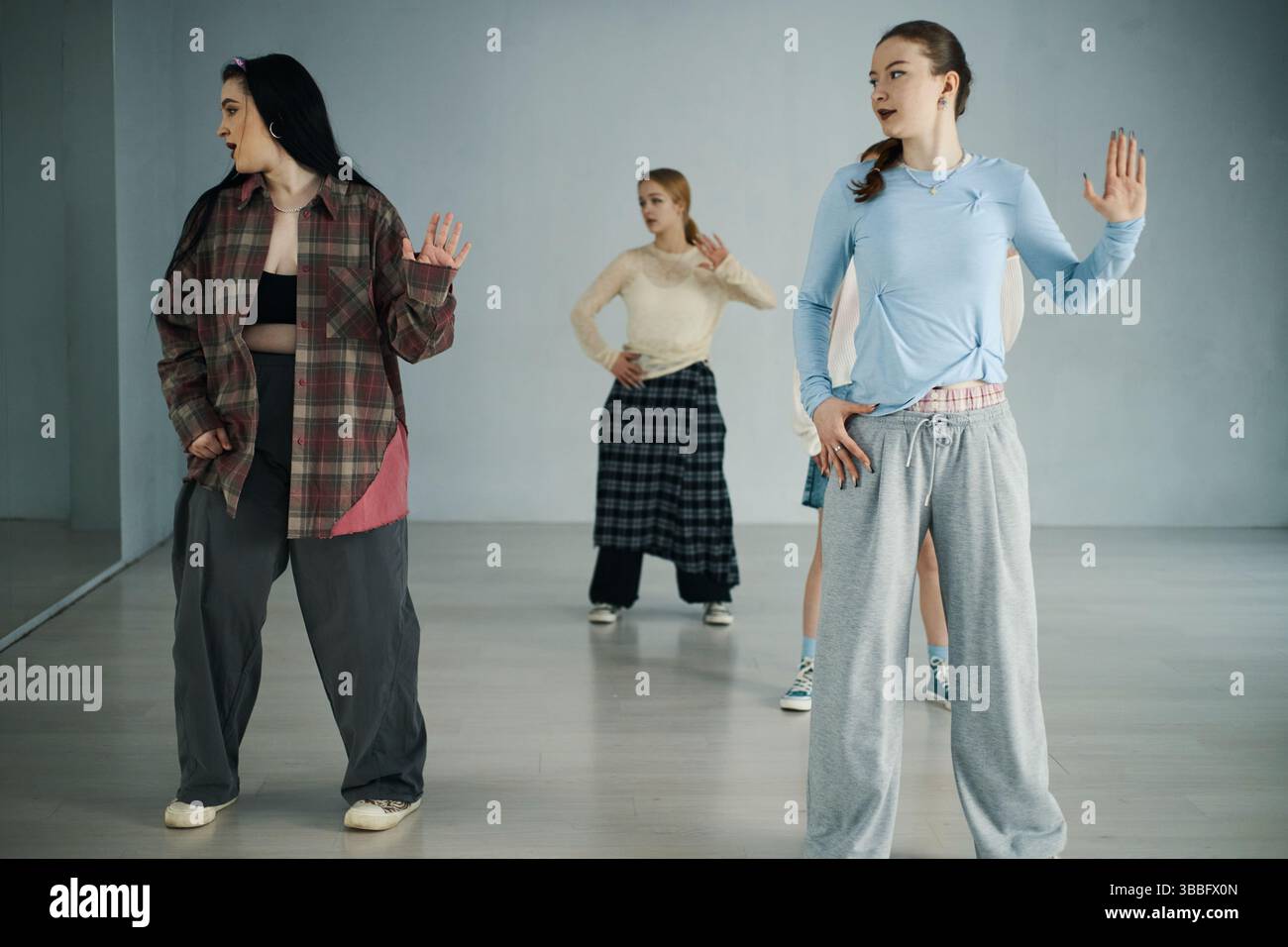 Practicing Dance Moves in Modern Studio Setting Stock Photo