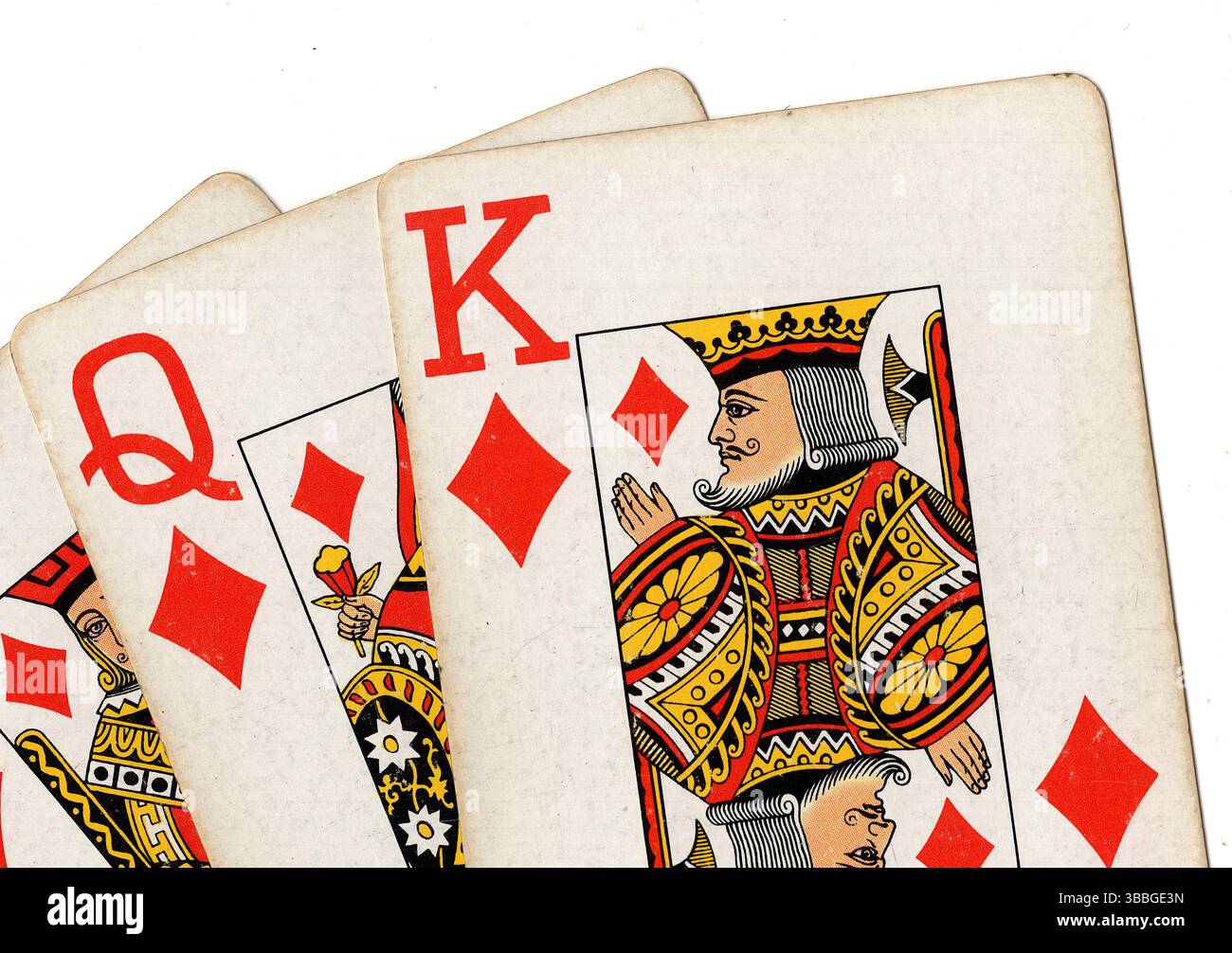 A run of three vintage playing cards in the same suit isolated on a ...