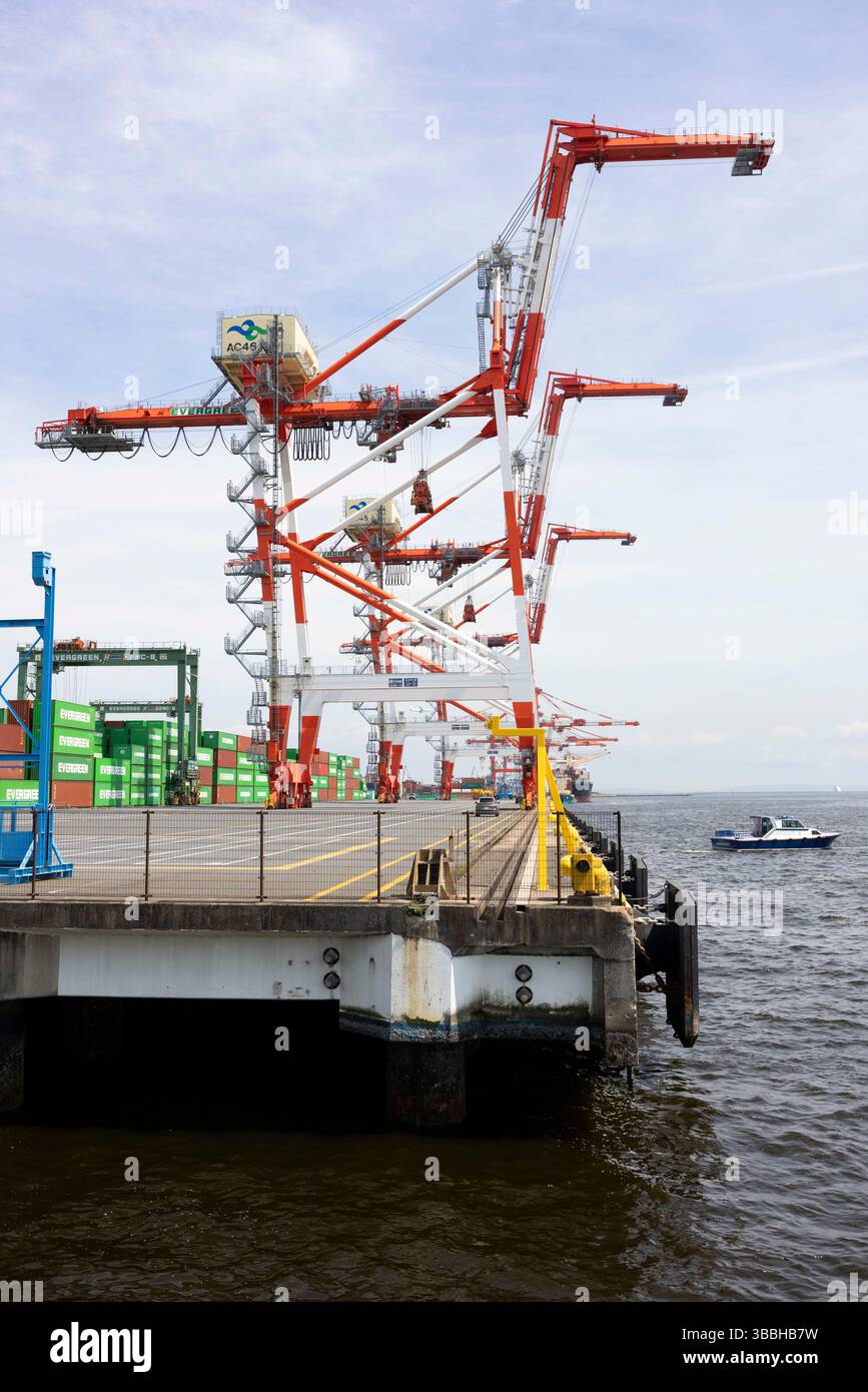 Container Pivoted Shipping container loads dock at Tokyo Bay. Japan is heavily reliant on ...