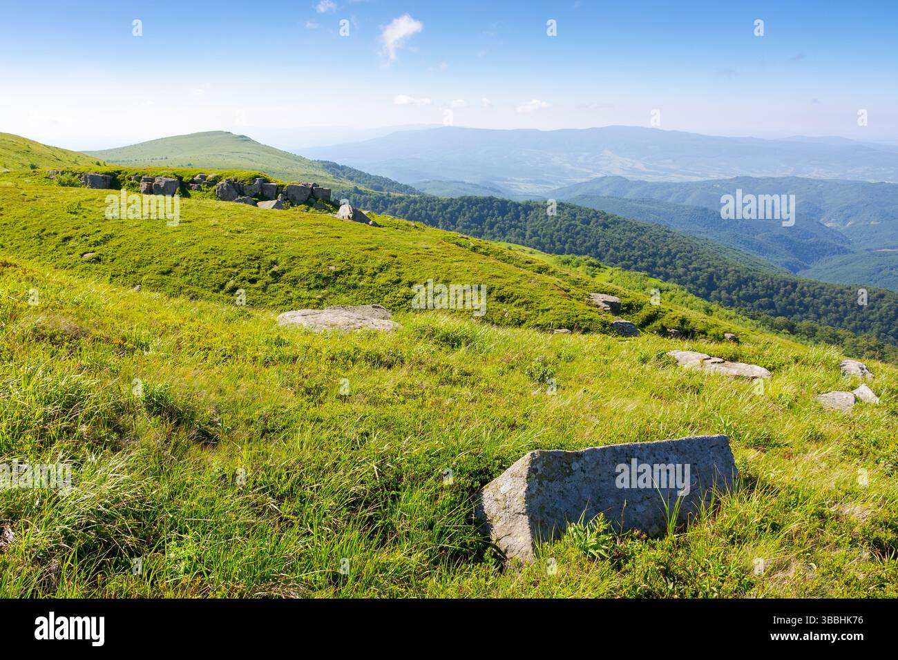 white sharp stones on the hillside. scenic travel destination of ukraine. lovely carpathian mountain landscape in summer. huge rocks scattered among a Stock Photo