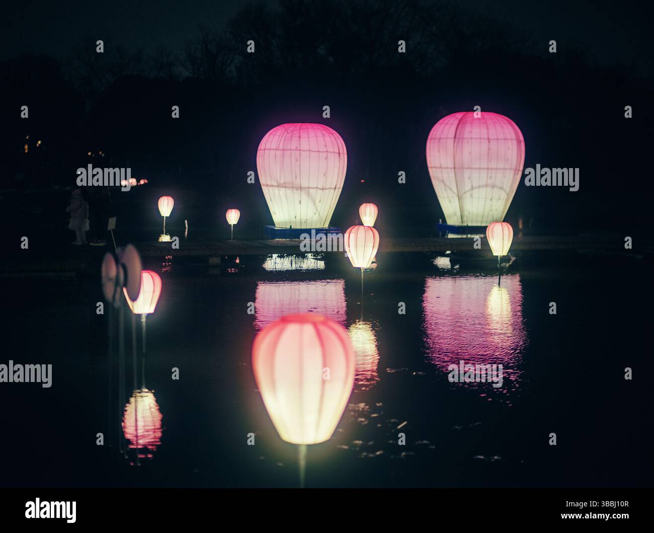 Pink Floating Lanterns Reflecting on Water at the Chinese Lantern Festival Stock Photo