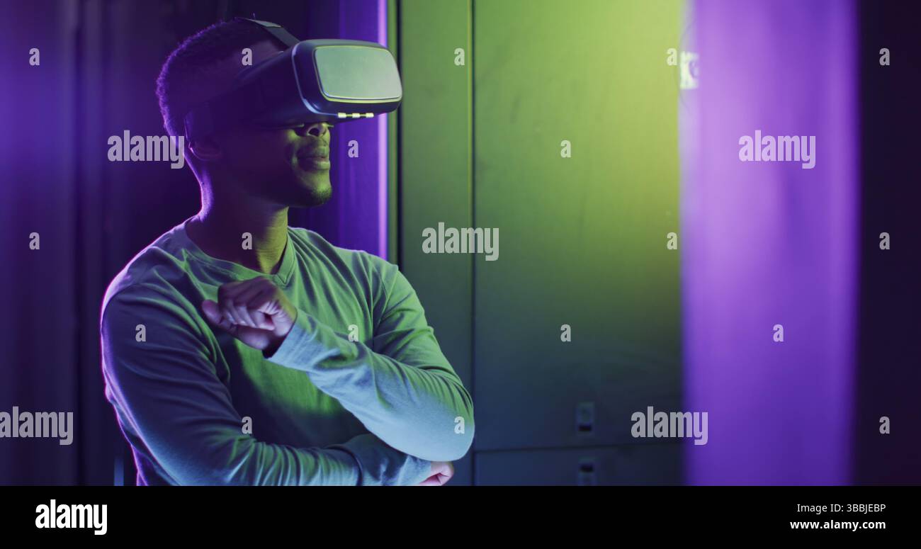 Image of data processing over african american man using vr headset in server room Stock Photo