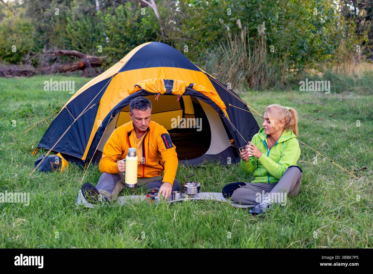 Couple having hot drinks in nature Stock Photo