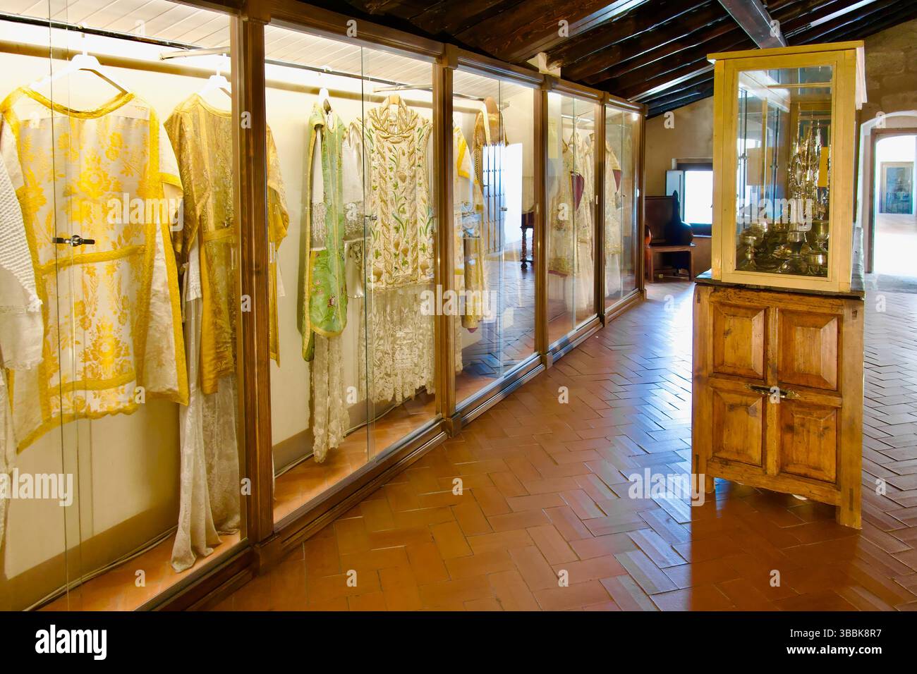 Collection of chasubles worn by priests for mass in a display case in the iglesia de San Martín Plaza Mayor Trujillo Caceres Extremadura Spain Europe Stock Photo