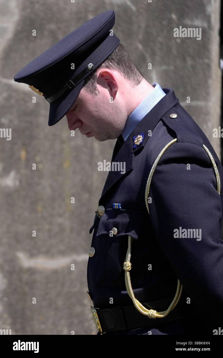 A Garda officer waits for the arrival of the funeral cortege of Garda ...