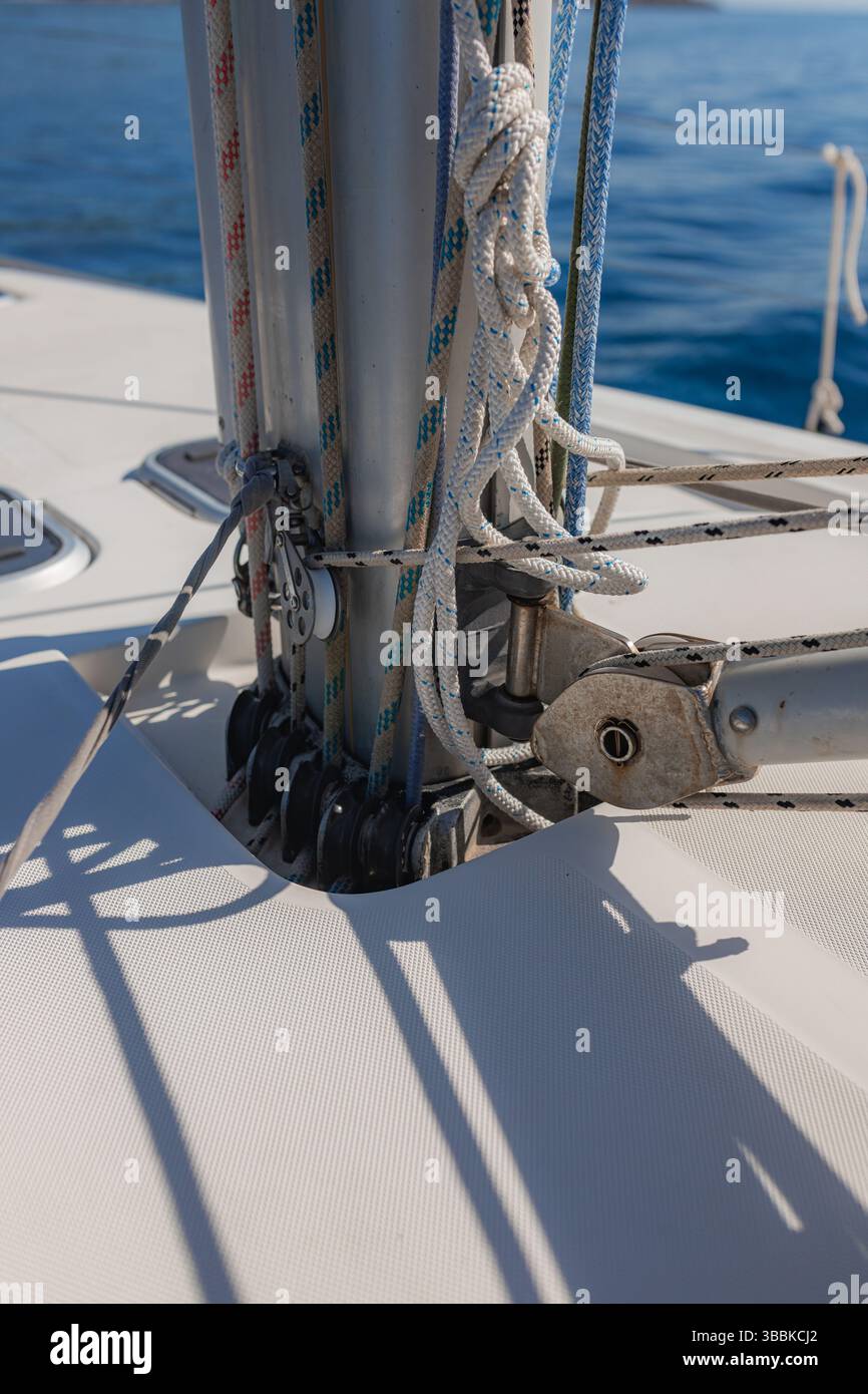 Close-up detailed view of yacht mast base with ropes and rigging on ...