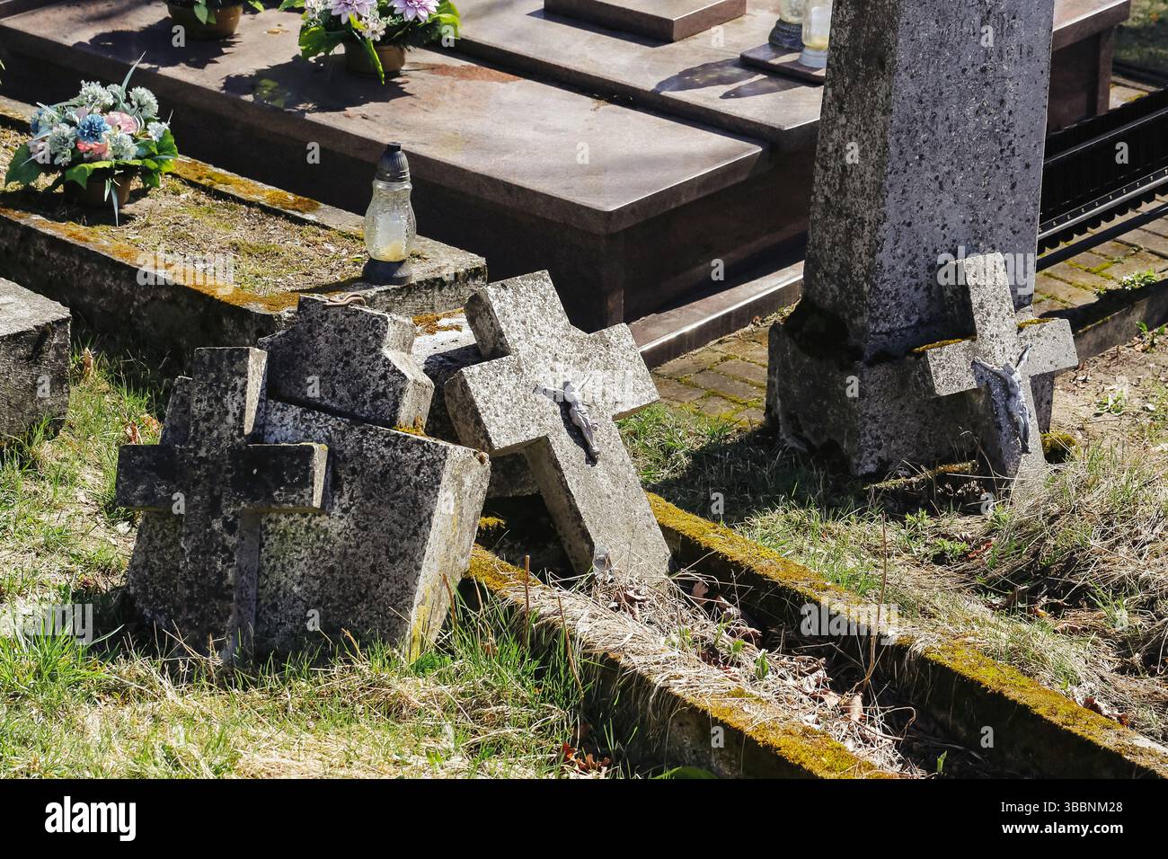 Old cemetery with broken tombstones. Fallen stone crosses on graves ...