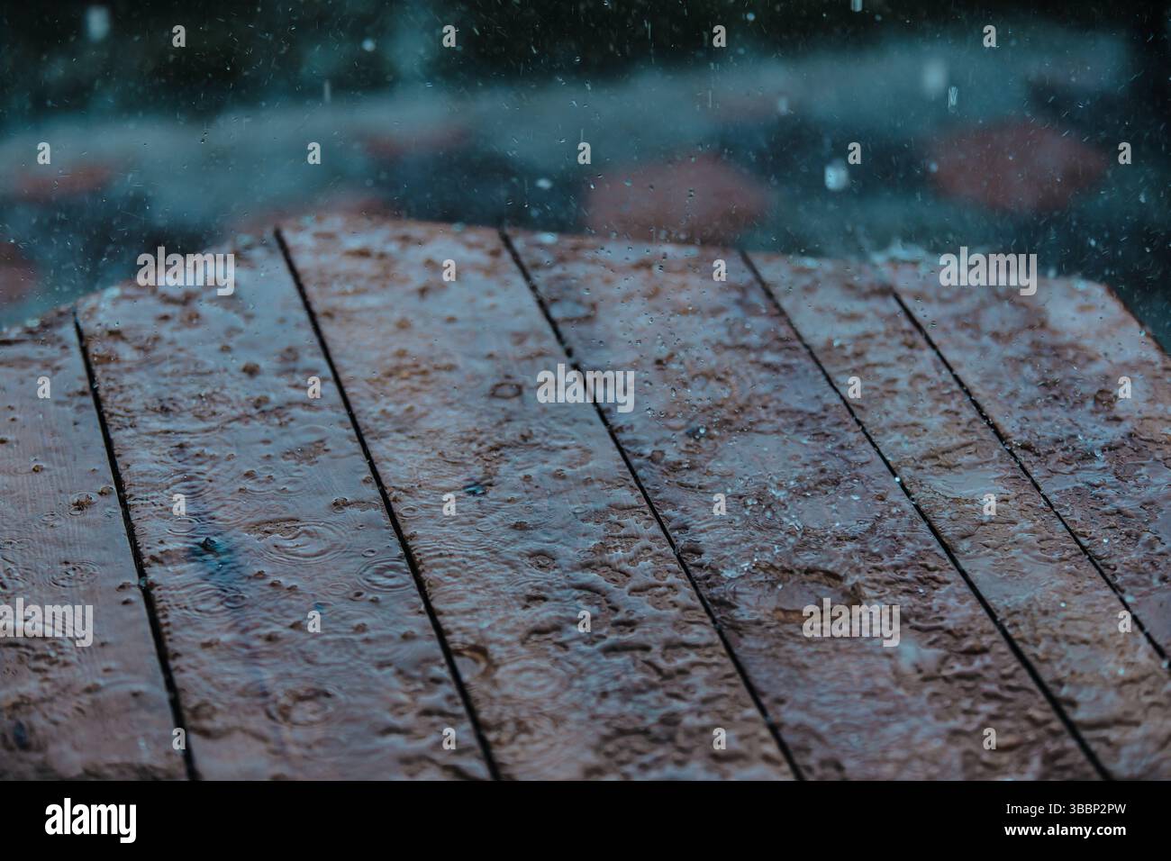 Raindrops on wooden table surface Stock Photo