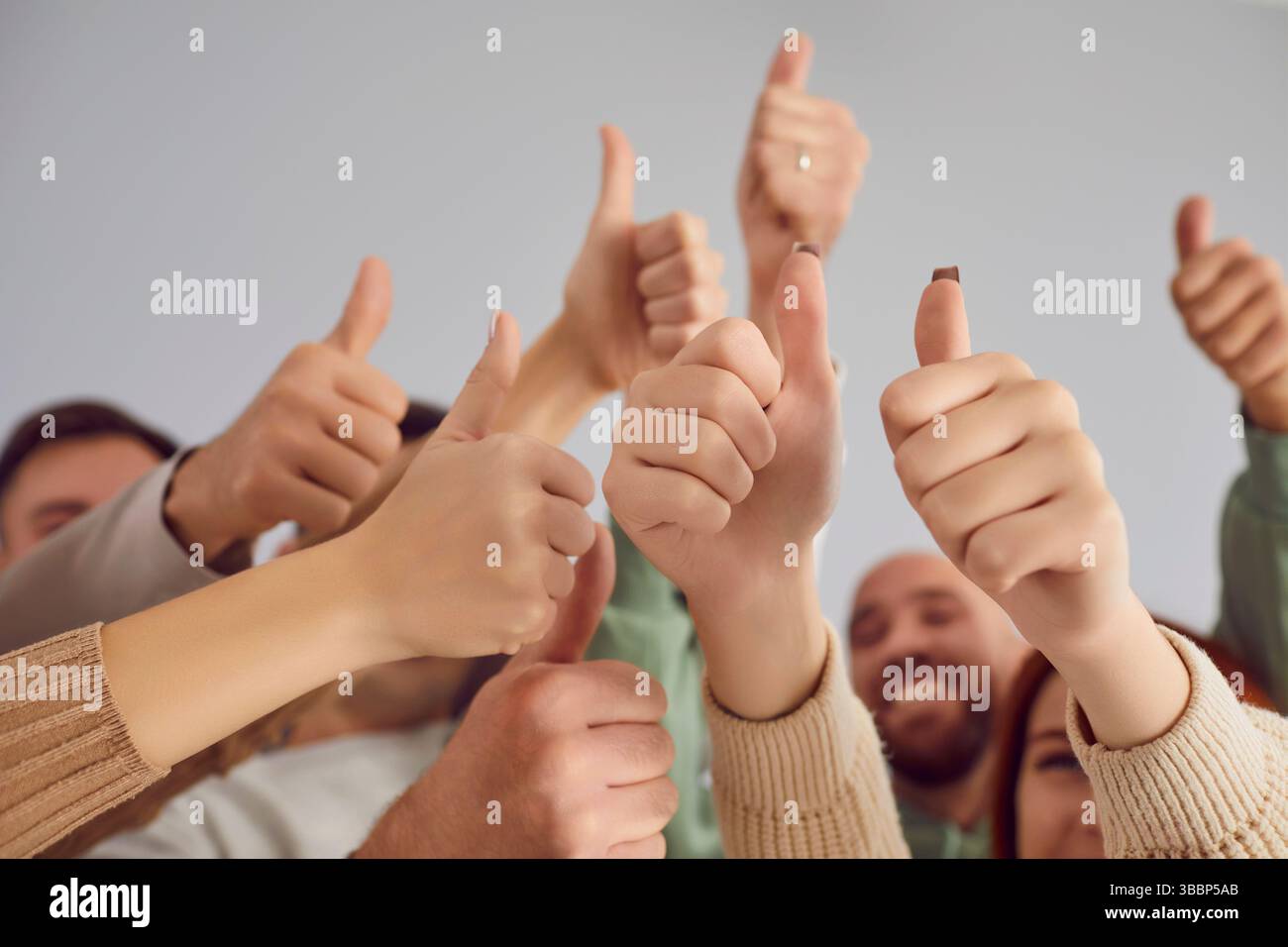 Team Showing Thumbs Up Gesture in Close Up Stock Photo