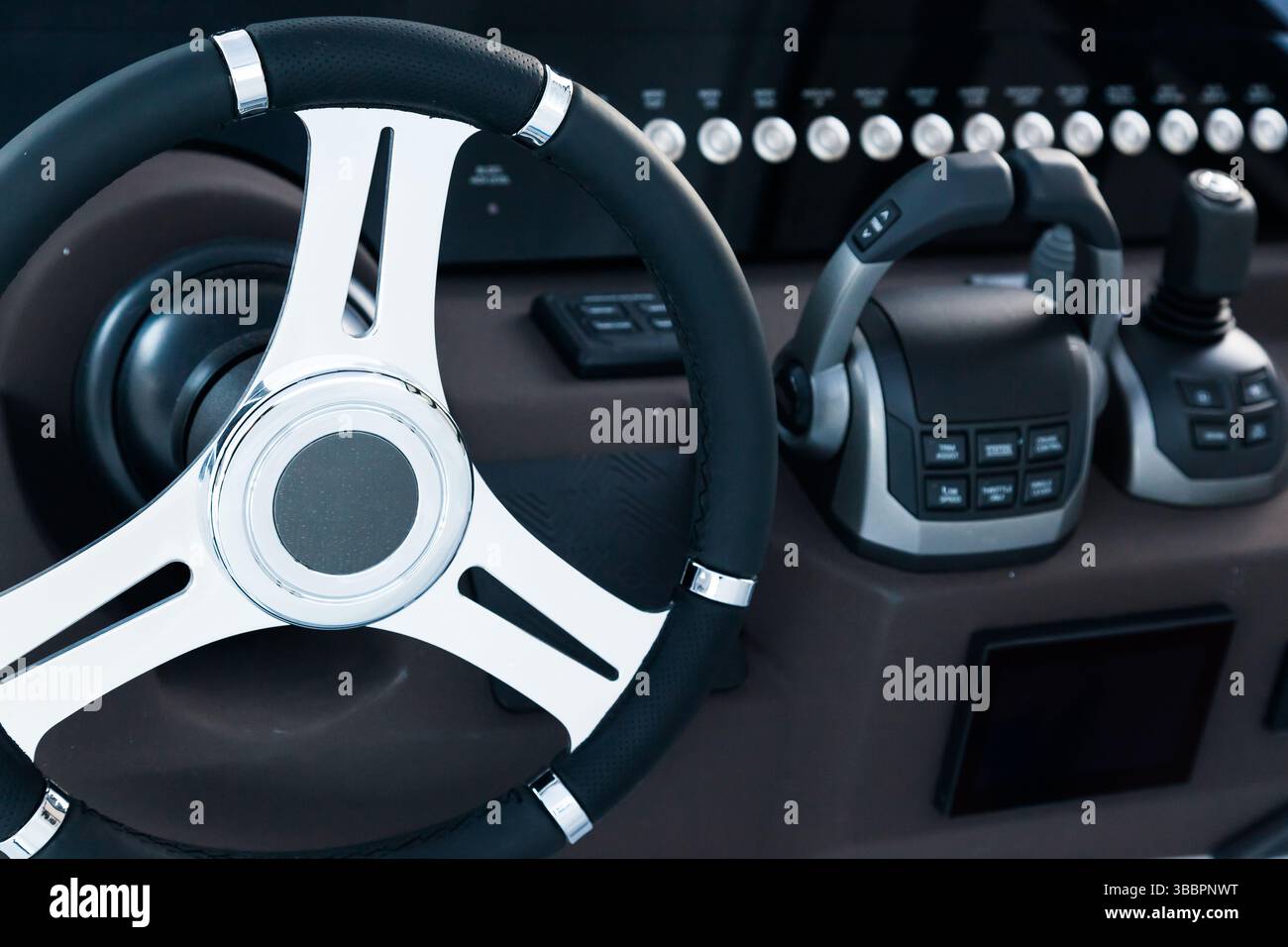 Motor yacht control panel. Steering wheel, gear levers, control buttons ...