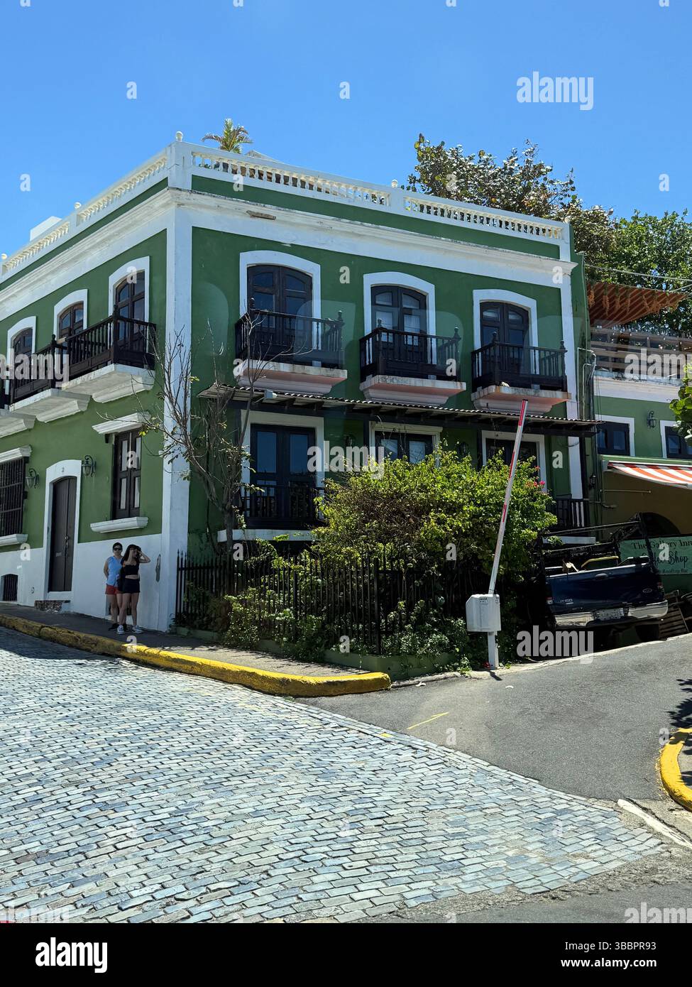 Colorful colonial architecture on a sunlit street corner in Old San Juan, Puerto Rico, captures the charm of historic Caribbean cities. - Smartphone Captured Stock Image