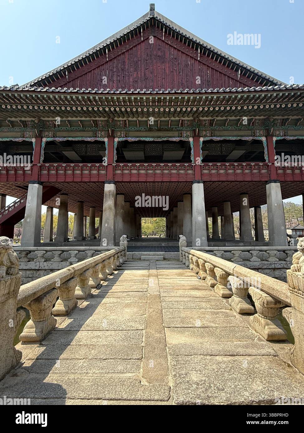 The grand Gyeonghoeru Pavilion at Gyeongbokgung Palace, Seoul, framed by stone bridges and spring sunlight — a symbol of royal Korea. - Smartphone Captured Stock Image