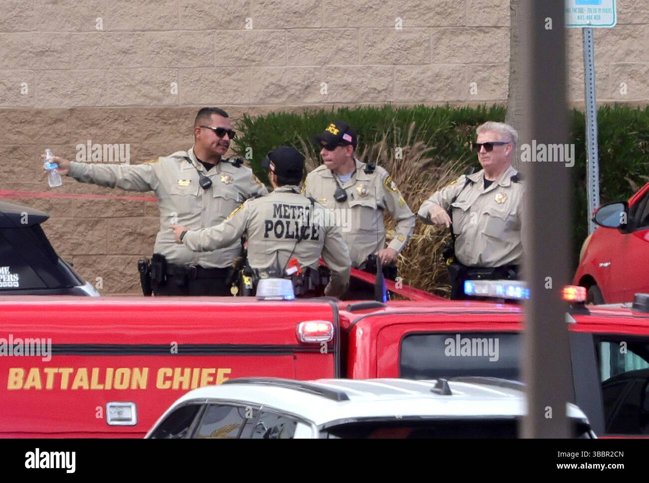 Las Vegas Metro Police officers confer by the main entrance of a Las ...