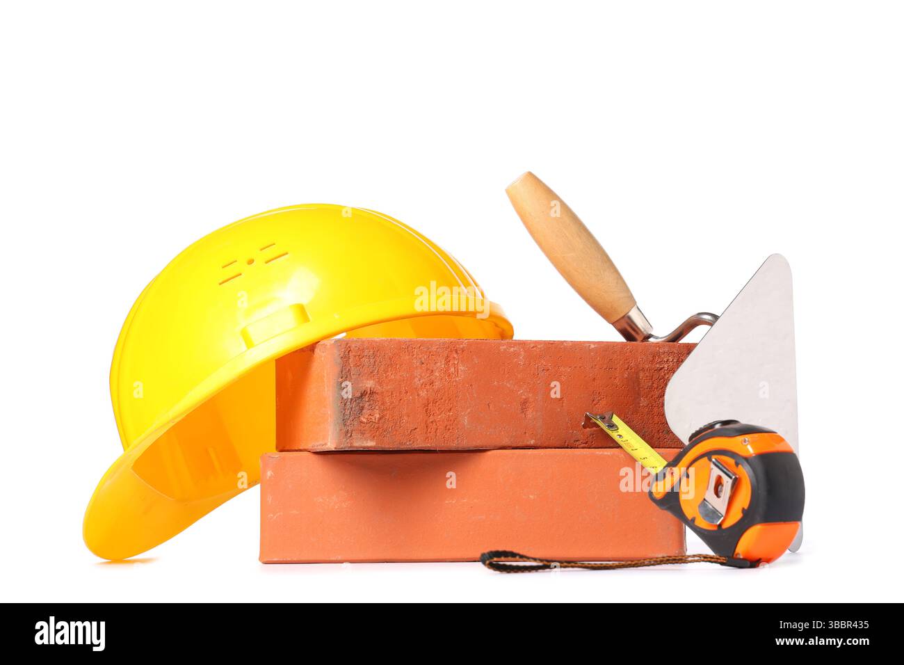Hardhat, bricks and construction tools on white background Stock Photo