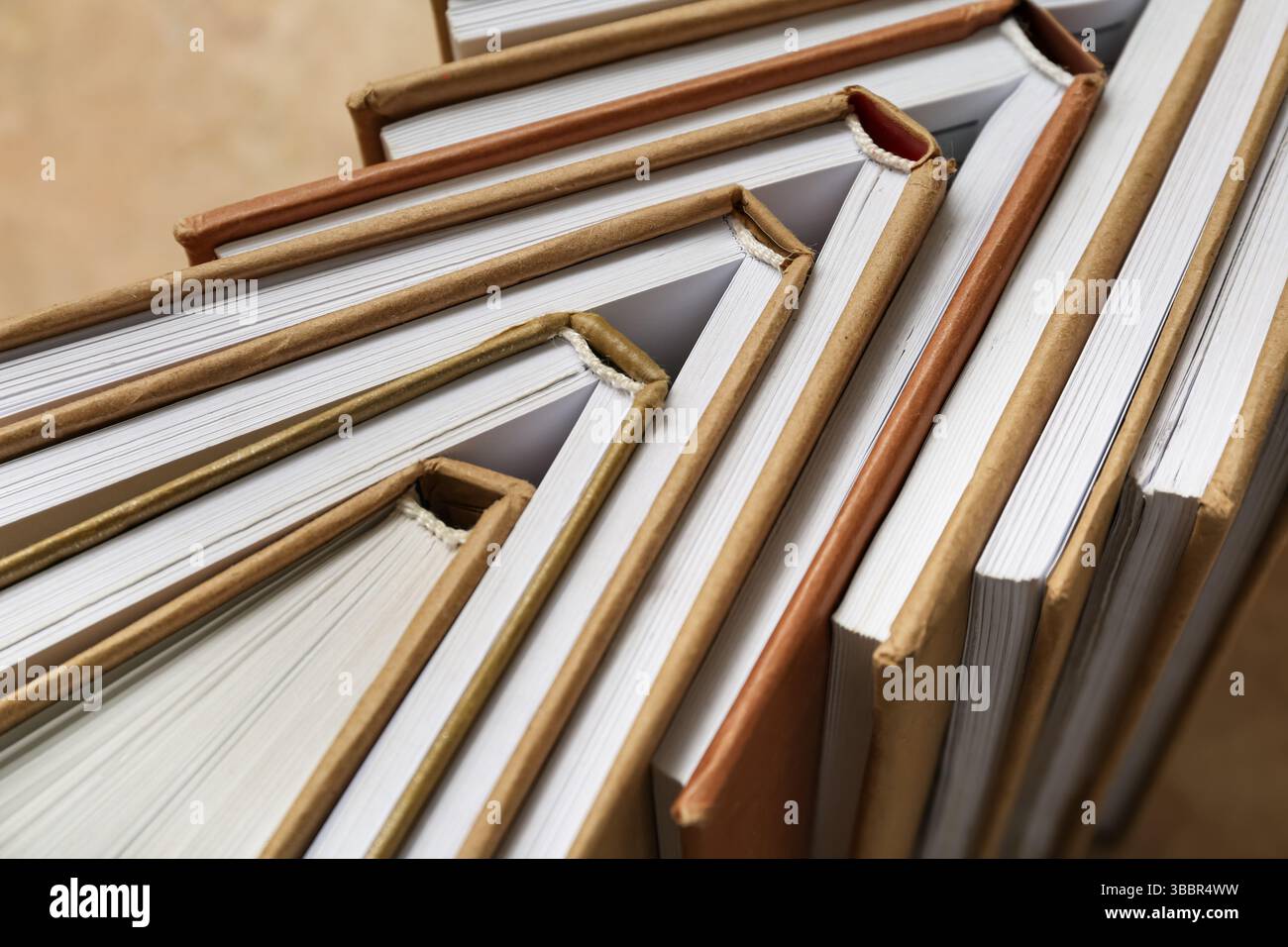 Many different half open books on beige grunge background Stock Photo