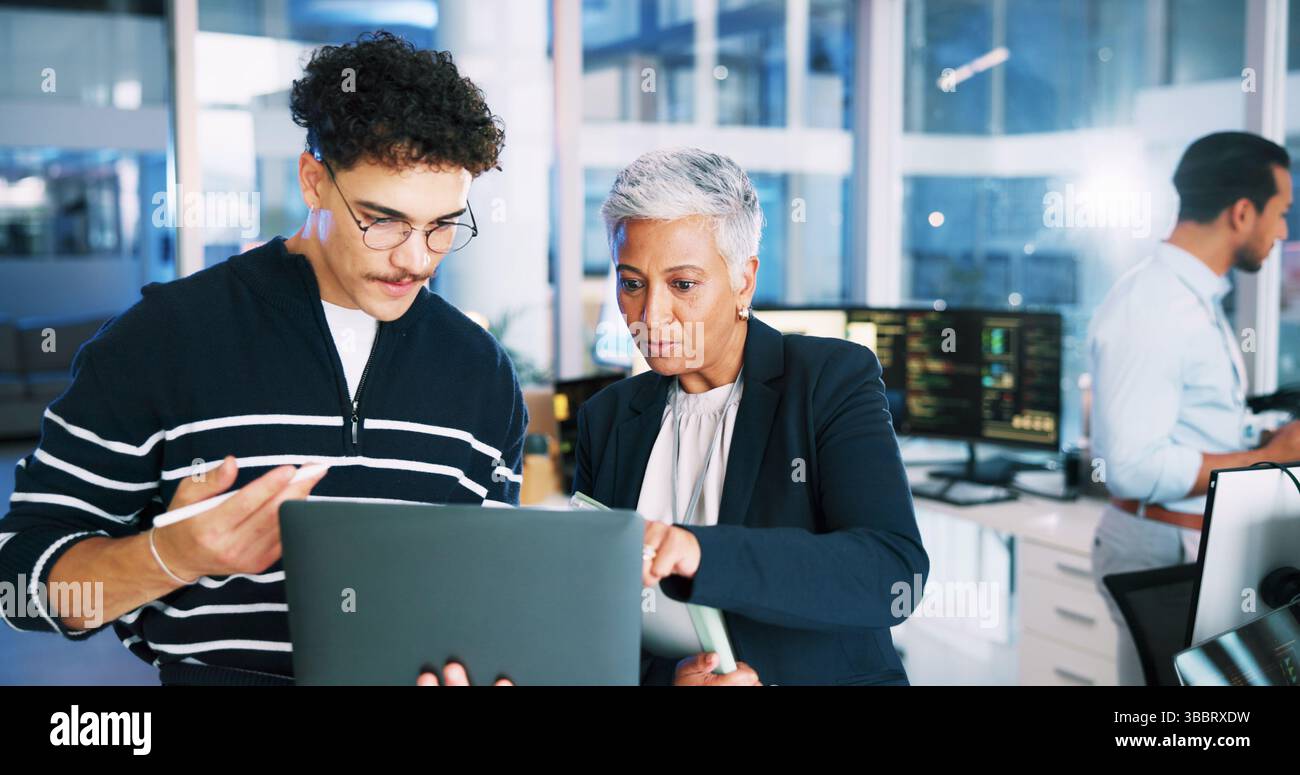 Man, developer and mentor on laptop in office for programming, coding training and server update. People, manager and help for testing pc, IT intern Stock Photo