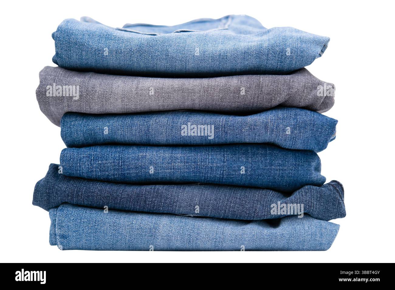 Stack of different jeans isolated on a white background. Stock Photo