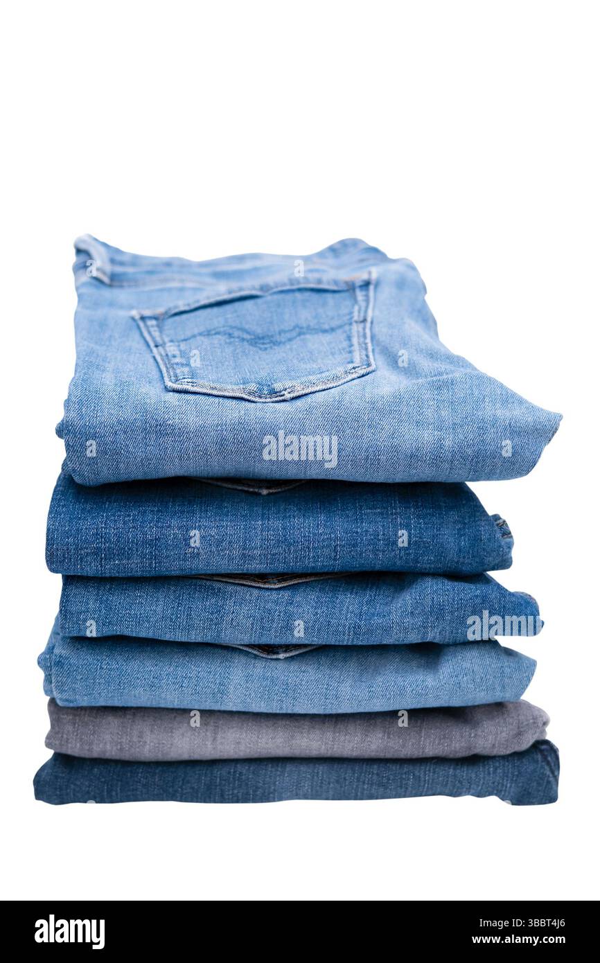 Stack of different jeans isolated on a white background. Stock Photo