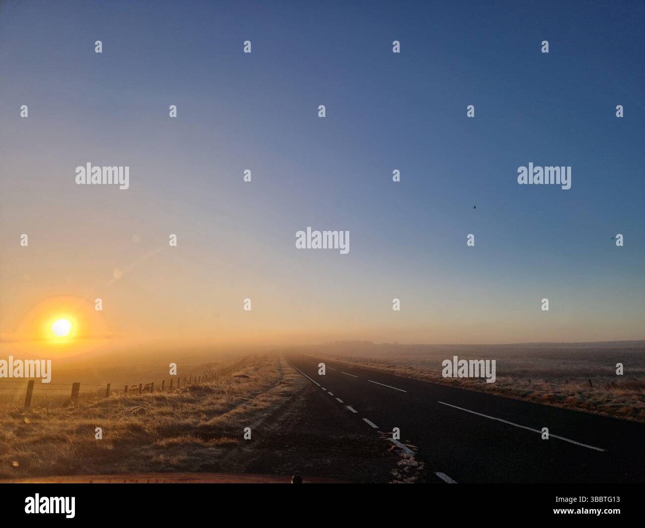 Sunrise over a misty moorland road in Northumberland, UK - Smartphone Captured Stock Image