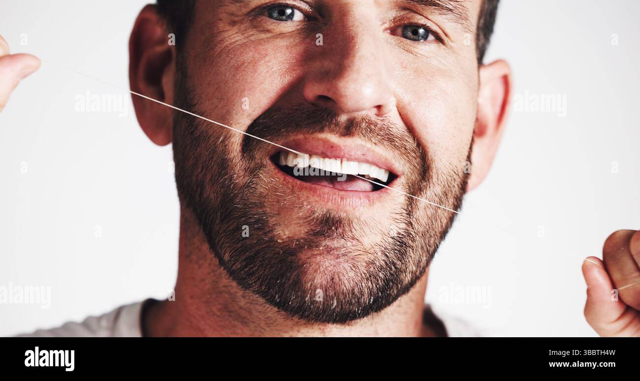 Dental health, studio and man floss teeth for oral hygiene, gum ...