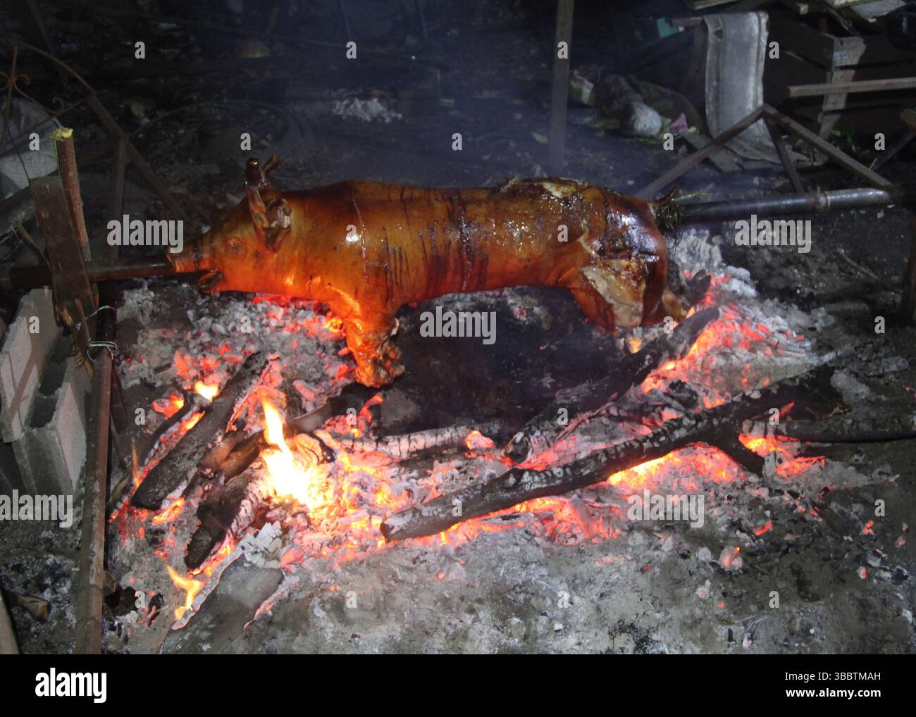 Pig being roasted on Charcoal Stock Photo