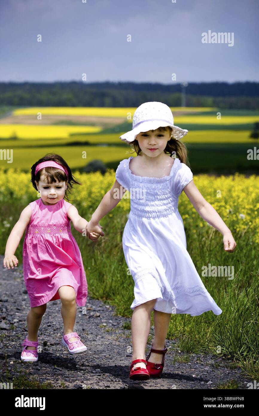 Little girls walking and ranking the fields Stock Photo - Alamy