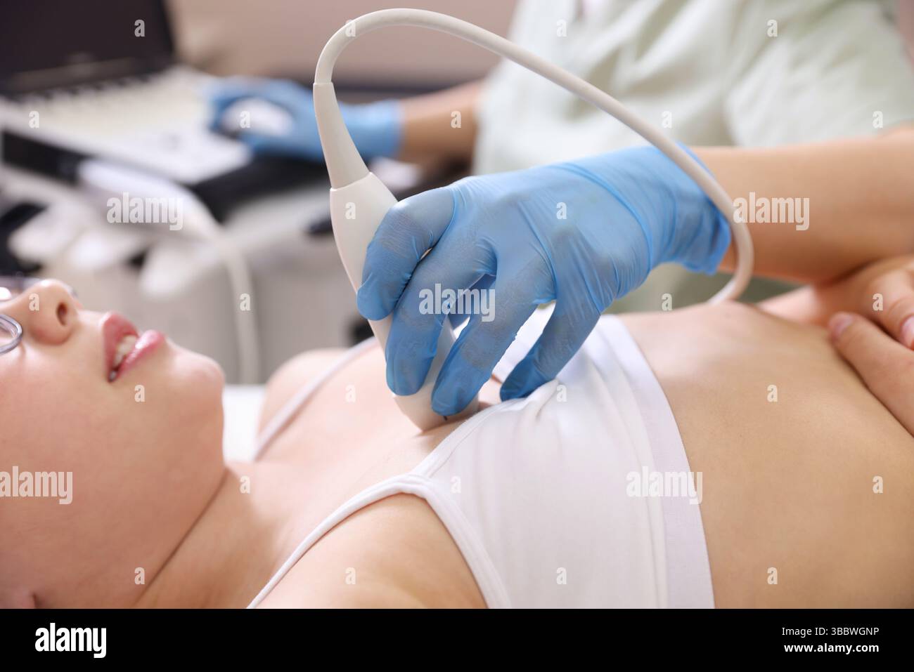 Sonographer Conducting Ultrasound Examination Of Girl s Heart In Clinic sonographer-conducting-ultrasound-examination-of-girl-s-heart-in-clinic