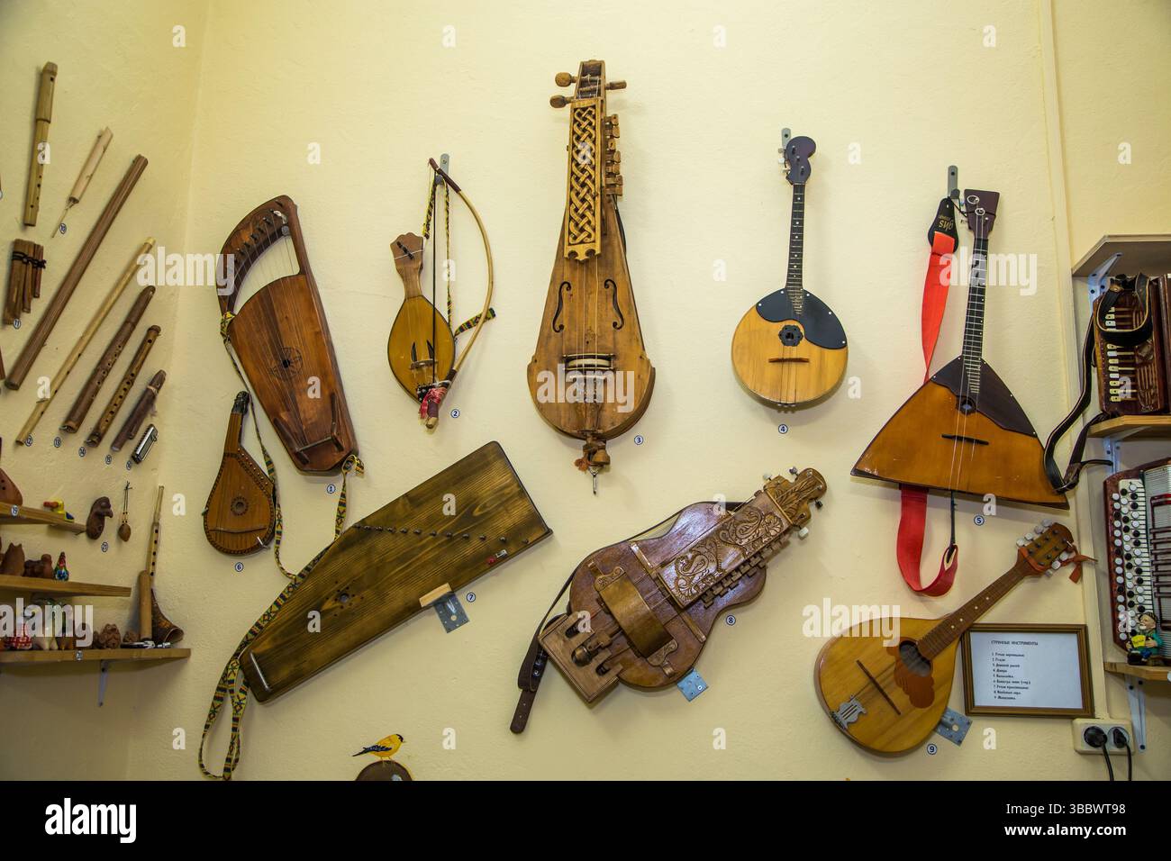 moscow, russia, 18.10.2016 A collection of old instruments, including a guitar, sit on a wall. The instruments are arranged in a way that creates a se Stock Photo