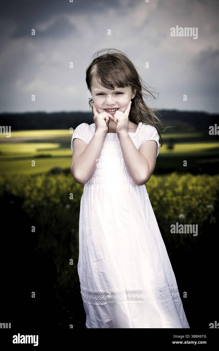 Little girl walking and ranking the fields Stock Photo - Alamy