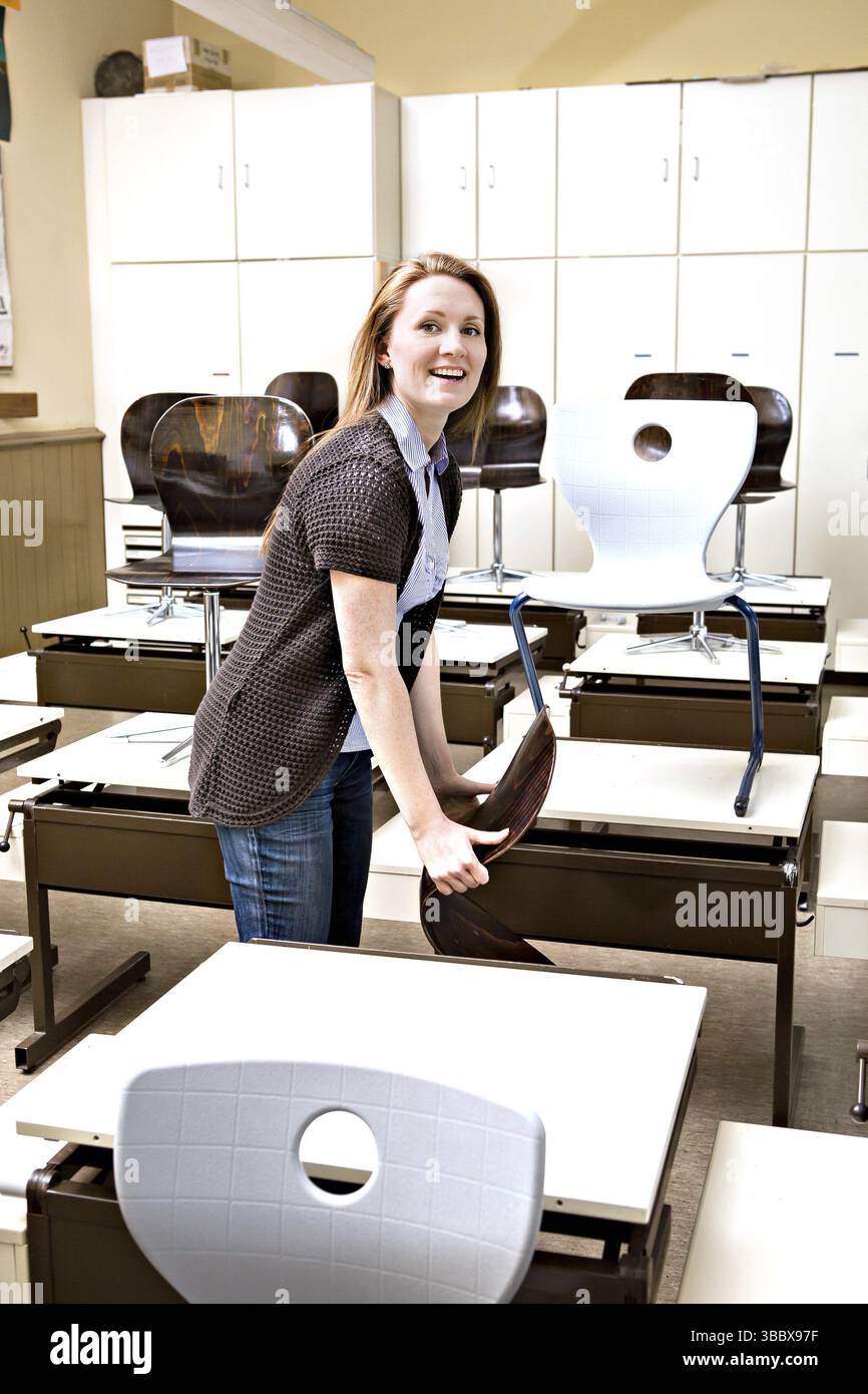 Portrait of a young female teacher in the classroom Stock Photo - Alamy
