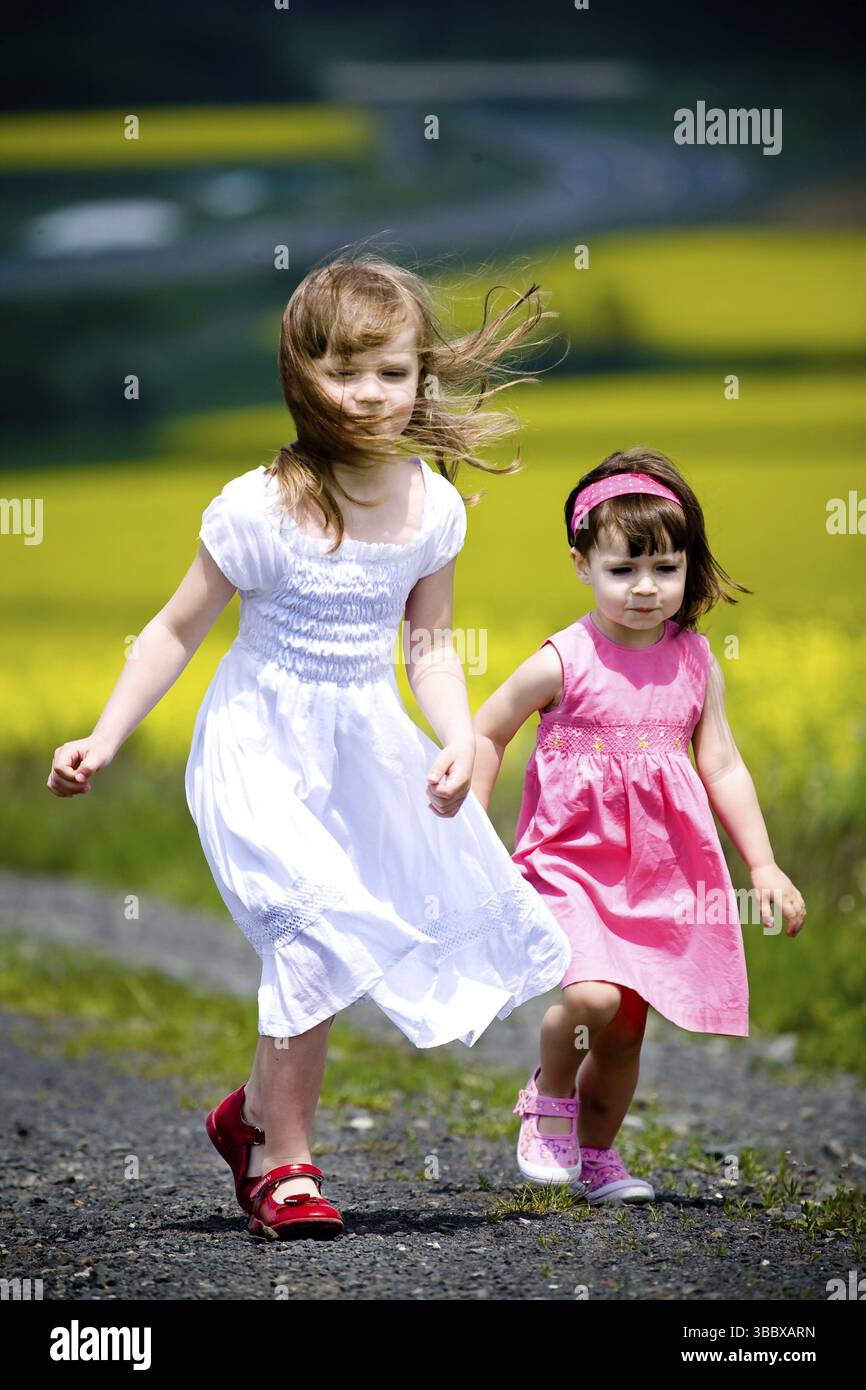 Little girls walking and ranking the fields Stock Photo - Alamy