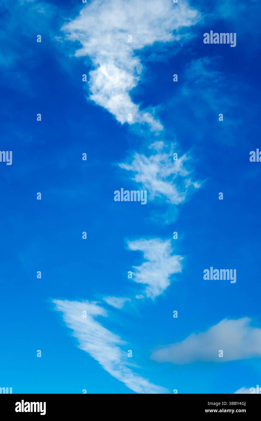 vertical view of trailing cluds in a blue sky Stock Photo