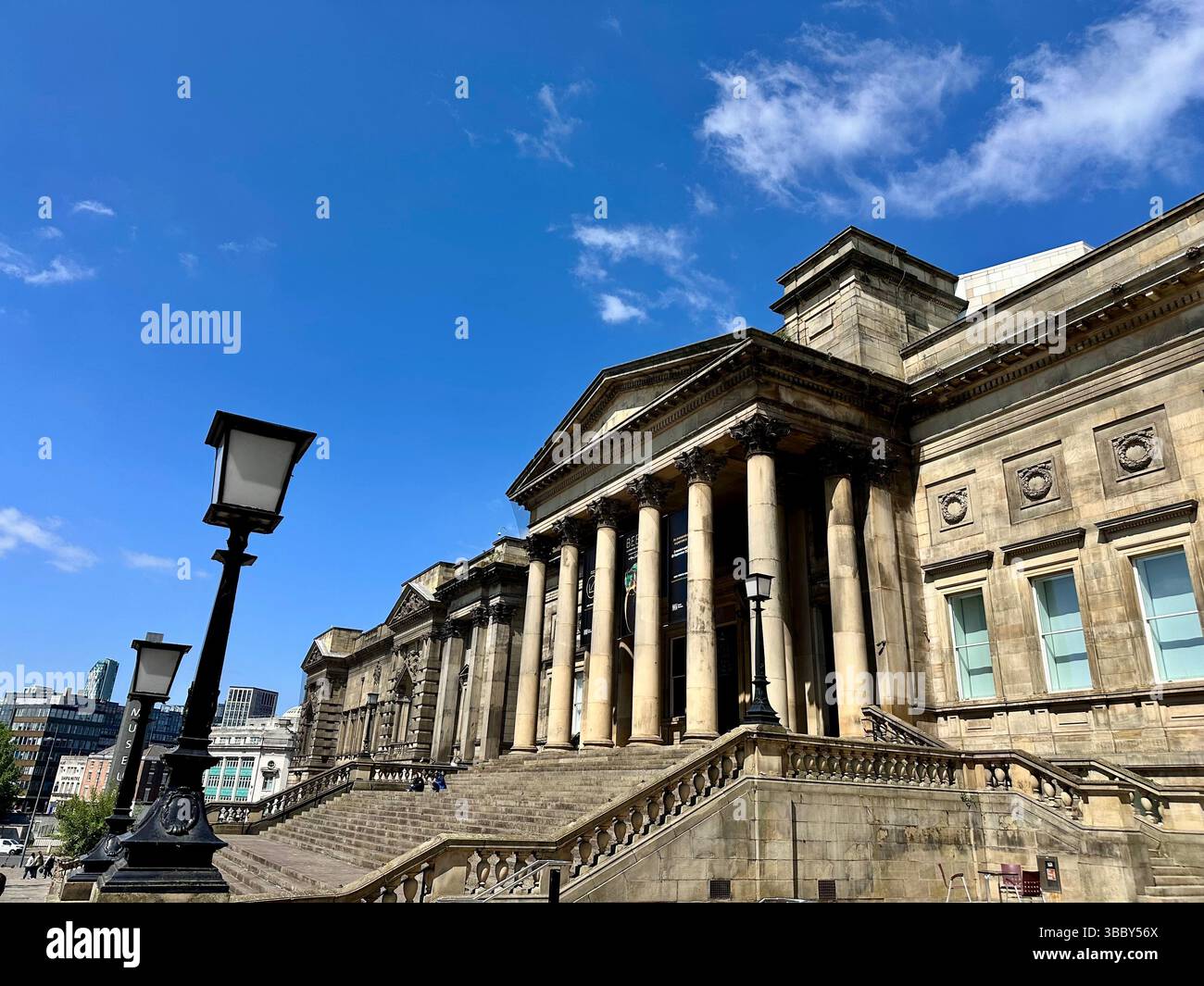 Liverpool Central Library with steps and lamppost under blue sky, 17 May 2025. View from right showing entrance and facade. Editorial use only. - Smartphone Captured Stock Image