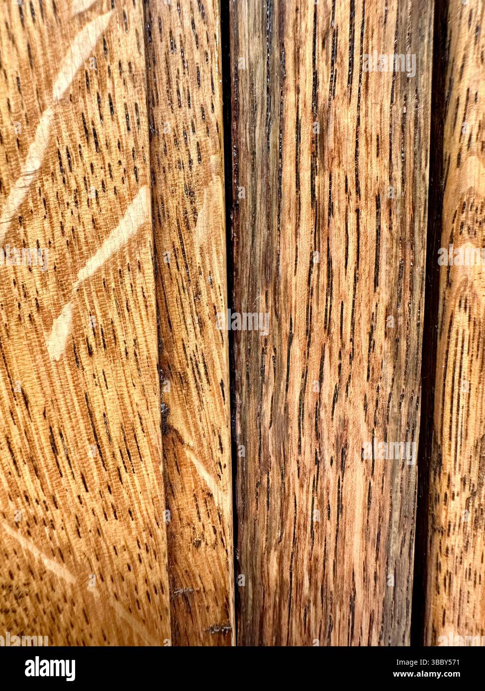 Close-up of polished mahogany wood with visible grain and overlapping panels creating a rich textured surface, ideal as a background or texture. - Smartphone Captured Stock Image