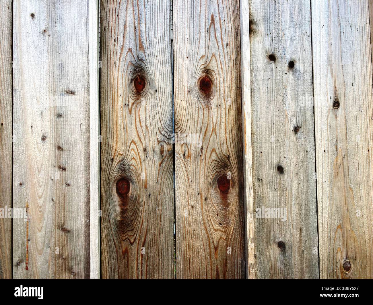 Wood grain and knots patterns in a plank of wood in an old outdoor wood ...