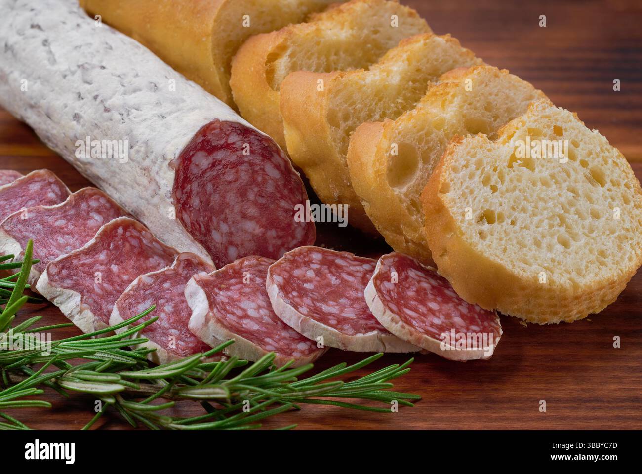 Fuet - traditional Catalan thin dry cured pork sausage with peculiar taste. Stock Photo