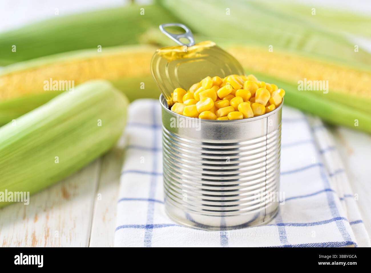 sweet canned corn on a white table, selective focus. Stock Photo