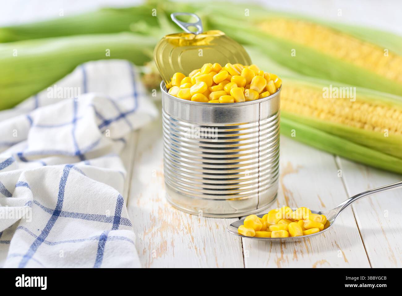 sweet canned corn on a white table, selective focus. Stock Photo