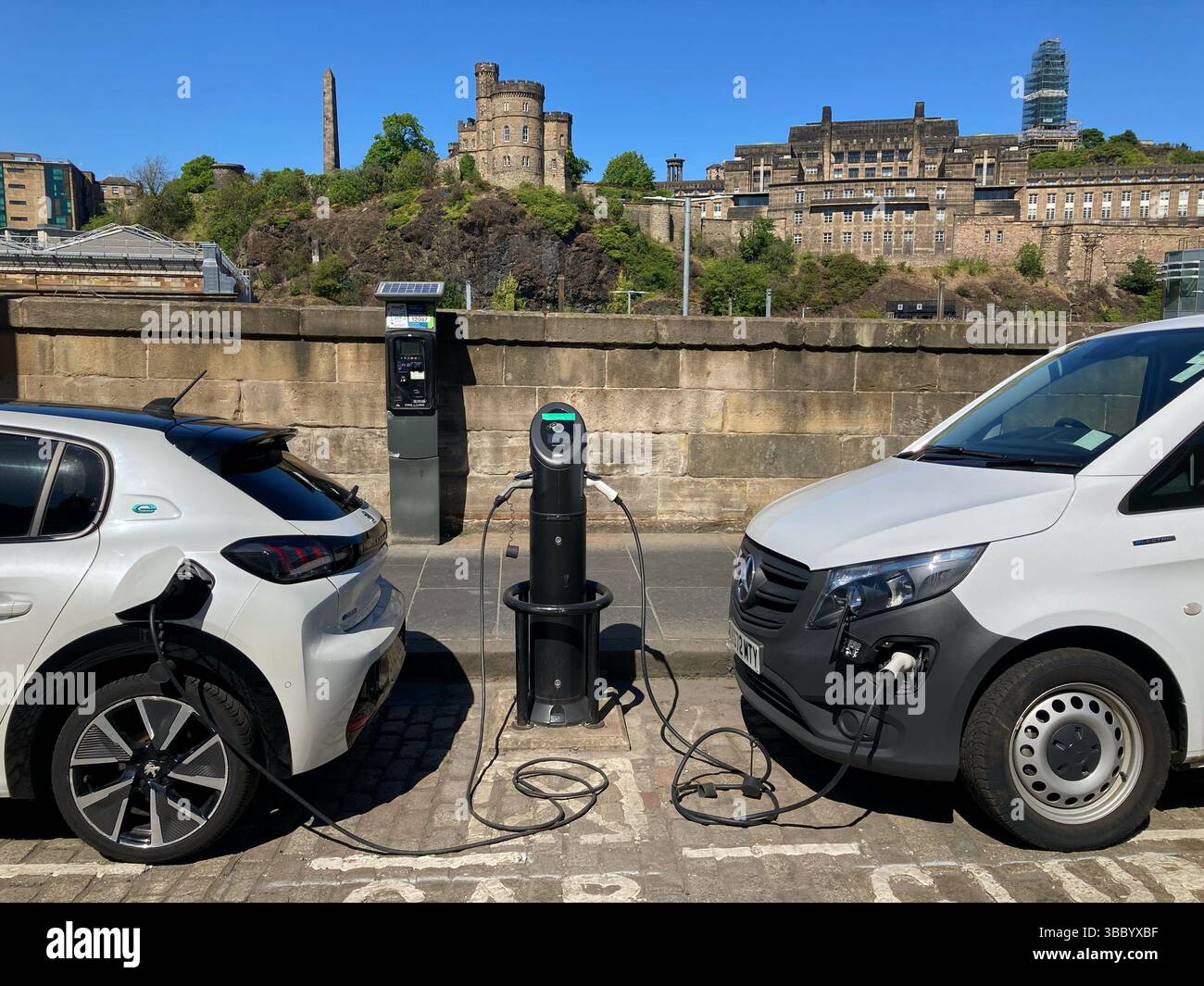 Electric vehicle EV Car charging point on street, East Market Street, Edinburgh Scotland - Smartphone Captured Stock Image