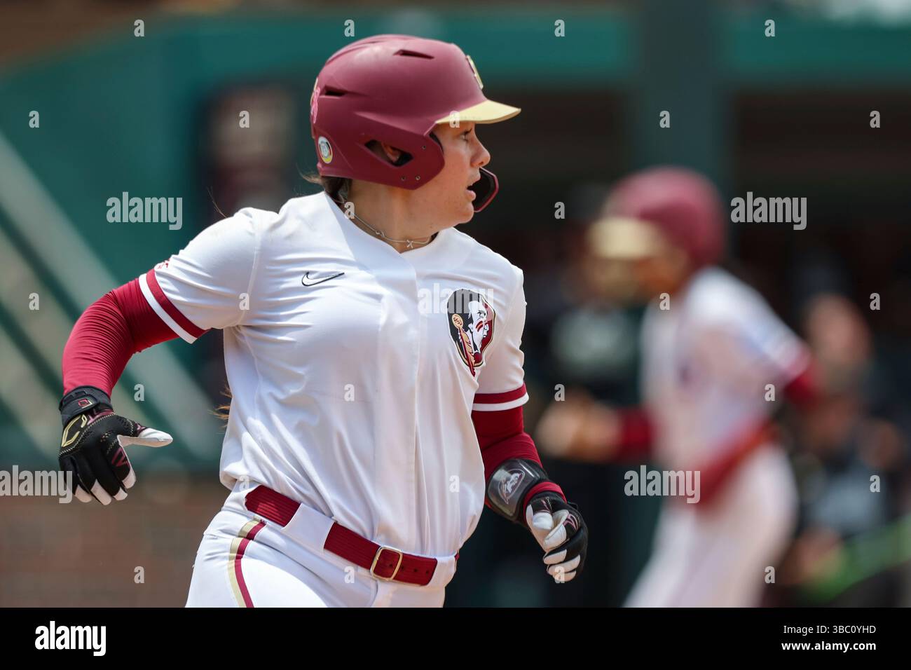 Florida State utility Katie Dack (77) rounds first during an NCAA ...