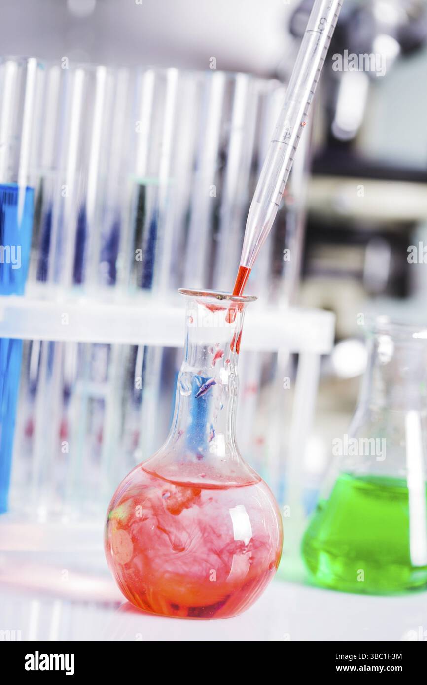 Scientist shows a diffusion in the flask Stock Photo