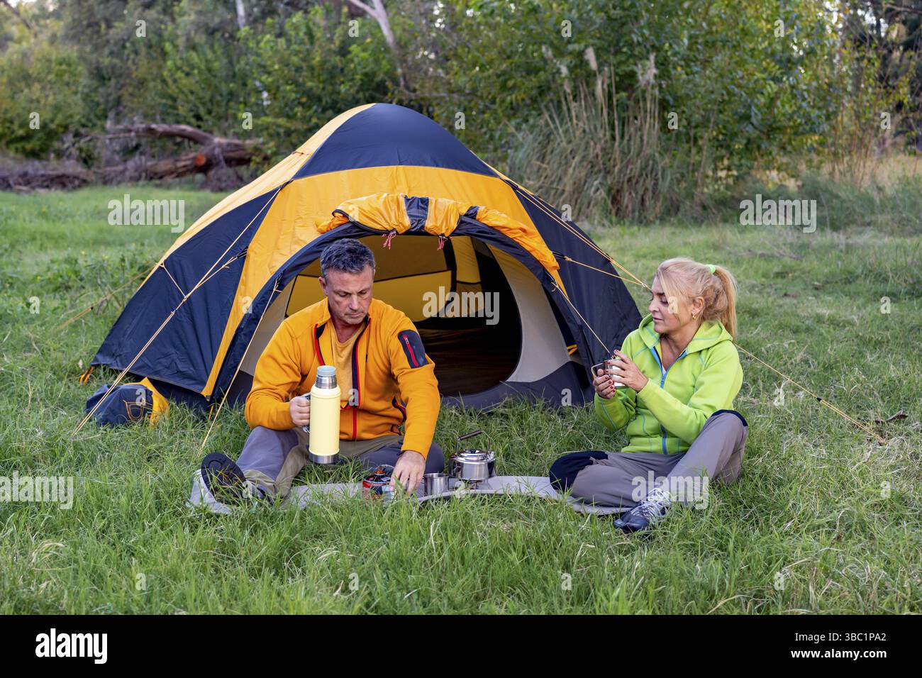 Couple having hot drinks in nature Stock Photo