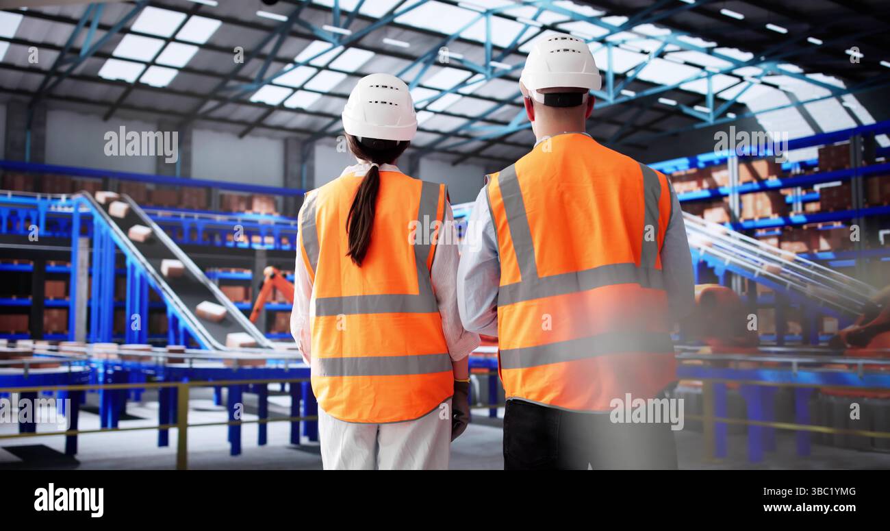 Warehouse Workers Strategize Packaging Process In Efficient Modern Distribution Center. Stock Photo