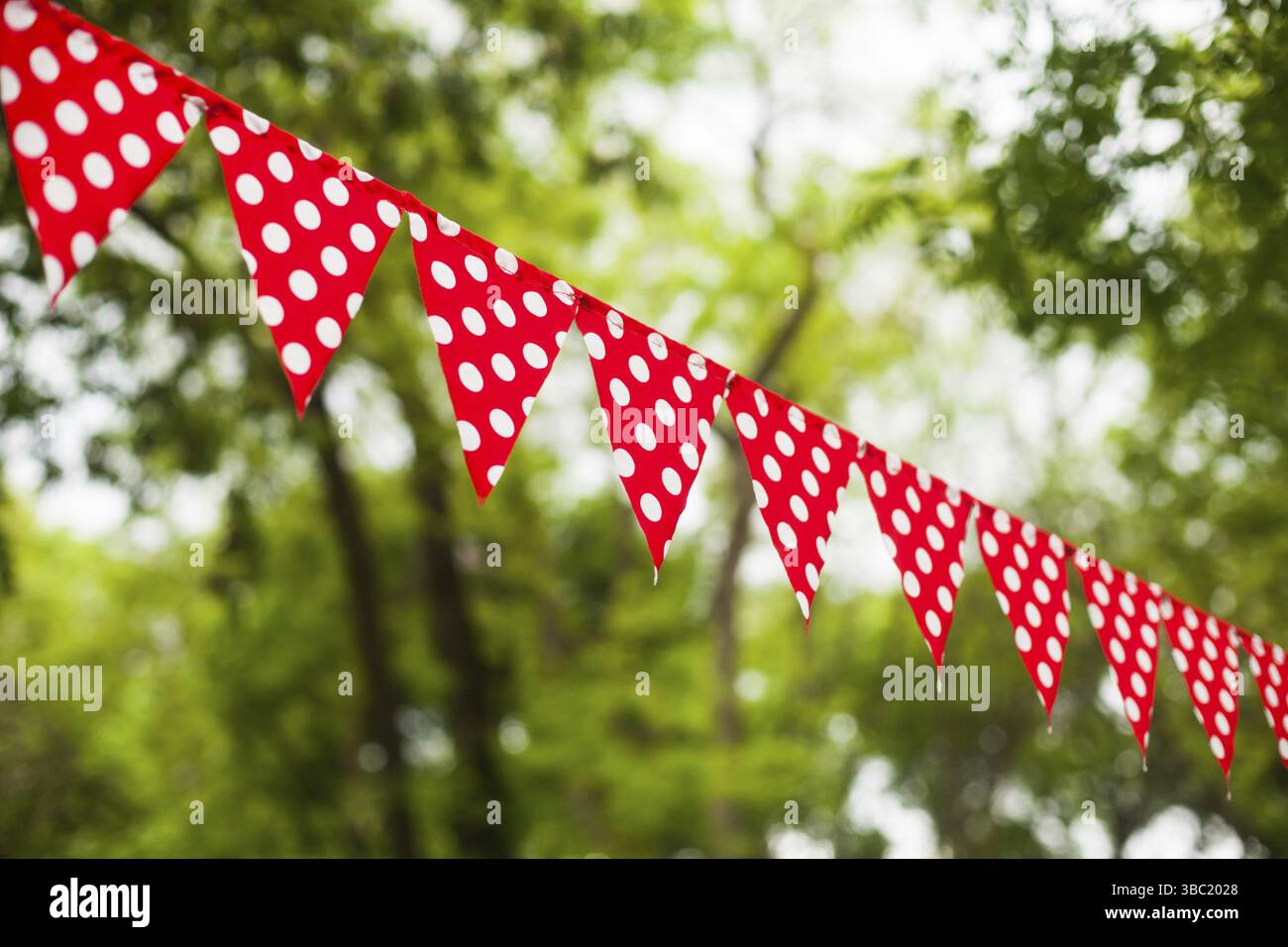 Red triangular flags with white dots on the nature background Stock ...